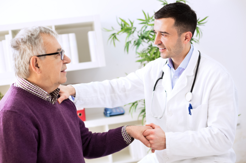 male doctor holding older male patient's hand topical combined with ingestible CBD